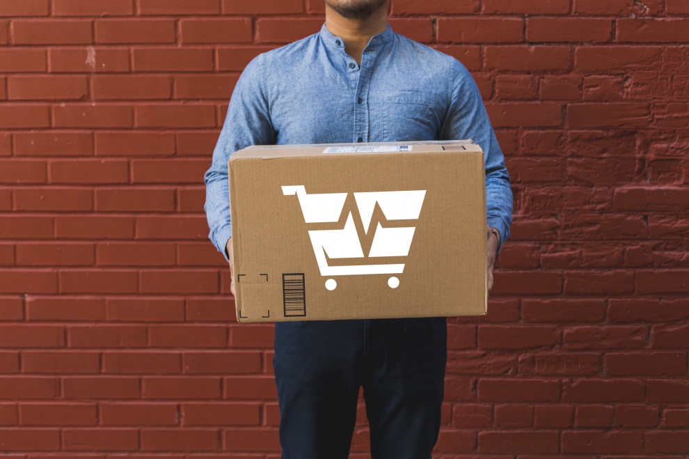 man-holding-shipping-box-on-red-brick-2.jpg