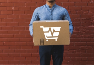 man-holding-shipping-box-on-red-brick-2.jpg